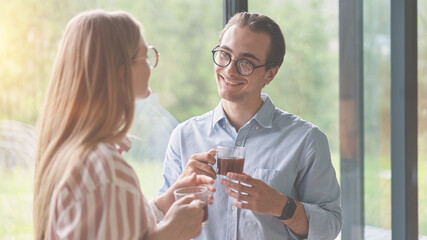 Young couple drinking coffee and discussing family business on the kitchen