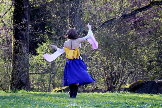 Girl In A Traditional Japanese Dress Dancing In Spring Garden. Cherry Blossom Season