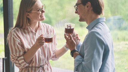 Side view of successful happy couple which drinking morning coffee