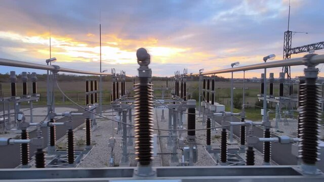 Aerial close up of High voltage sub station for electric power distribution Long-range energy transmission during epic sunset