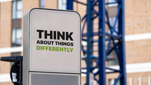 Think About Things Differently Sign In A Busy City Centre
