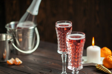 Two glasses of  champagne on dark wooden background. Festive drink. Valentins or Christmas concept.