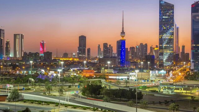 Skyline with Skyscrapers day to night timelapse in Kuwait City downtown illuminated at dusk. Kuwait City, Middle East