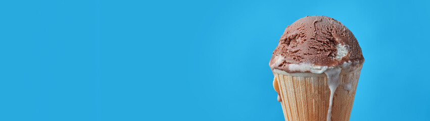 Ball of chocolate ice cream in waffle cone with copy space banner