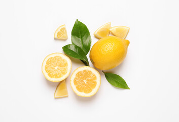 Flat lay composition with fresh juicy lemons and green leaves on white background