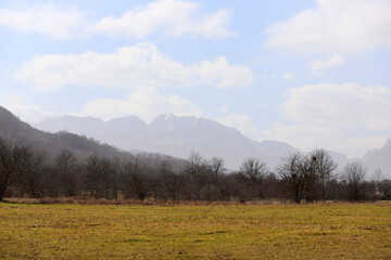 Fototapeta na wymiar Beautiful dry field with mountains silhouettes.