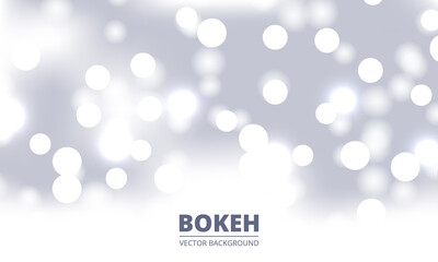 White and silver bokeh background. Holiday glowing silver lights with sparkles. Festive defocused lights. Blurred bright abstract bokeh on light background.