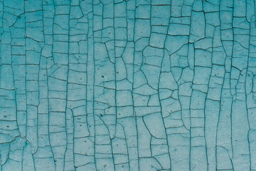 Old paint texture wood background. Blue peeling paint on a wooden surface.