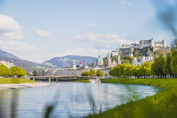 Fototapeta premium Salzburg summer time: Panoramic city landscape with Salzach with green grass and historic district