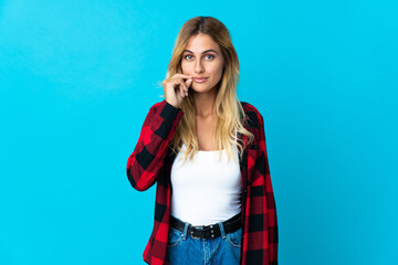Young blonde Uruguayan woman over isolated background showing a sign of silence gesture