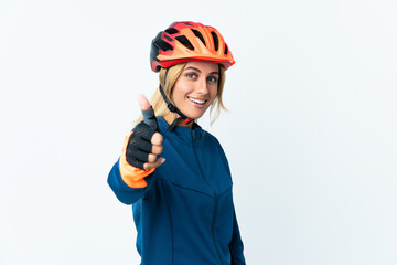 Young blonde Uruguayan cyclist woman isolated on background with thumbs up because something good has happened