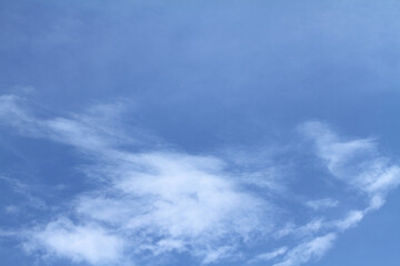 Beautiful blue sky and white clouds of various shapes with sunlight Nature background