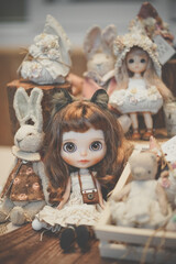 Cute dolls on display at doll shop. Vintage dolls. Soft focus on the blythe doll (attached with property release). Vintage filter and slightly  film grained effect.