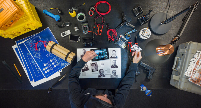 Bomber looks at a photo of the victim and counts the notes.