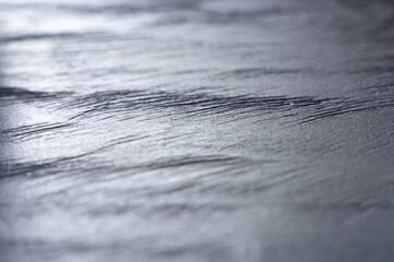 Natural light on grey wood plank. Gray background texture with shallow depth of field