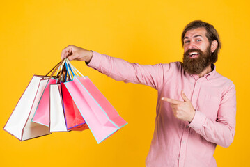 mature brutal hipster with shopping bag in shirt, valentines day