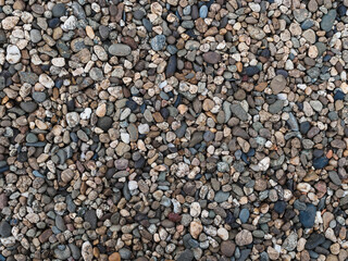 texture: many small stones of different colors close-up - decorative fence