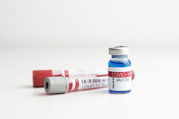 Coronavirus vaccine bottle with blood tube.Vaccination covid-19, medical research and development concept.