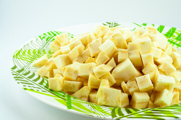 Pieces of celery root, fresh raw vegetable, healty diet plant, fresh salad on dinner plate, isolated object, design element
