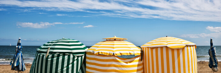Beach umbrellas, Deauville, Normandy, France. Panoramic summer background.