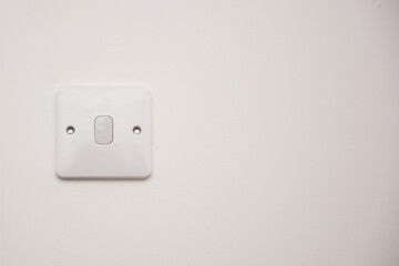 Light switch on a white wall
