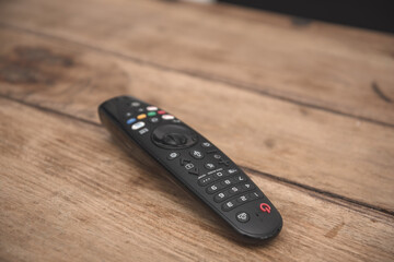 TV remote control isolated on wooden coffee table
