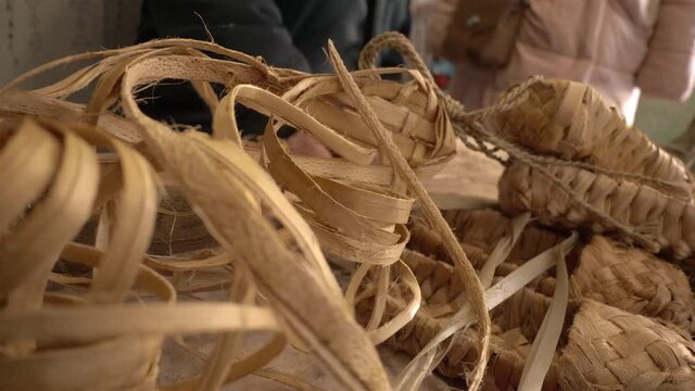 The village master weaves bast shoes.