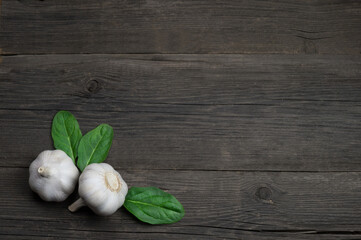 Fresh fragrant garlic cloves on a wooden background. Vegetables ingredients for cooking.