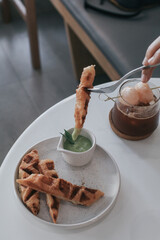Waffle sticks with Thai Pandan Custard on the plate. Really popular dessert in Thailand 