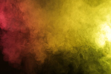 Smoke in red-yellow light on black background