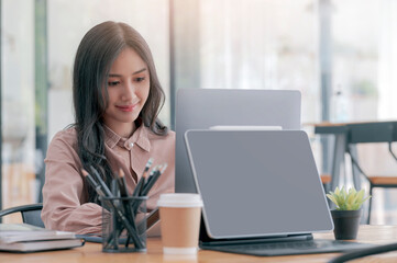 Young asian woman working on computer at office.