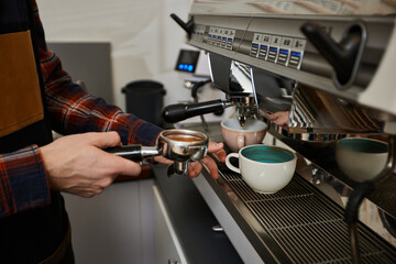 Barista using a coffee machine to make coffee
