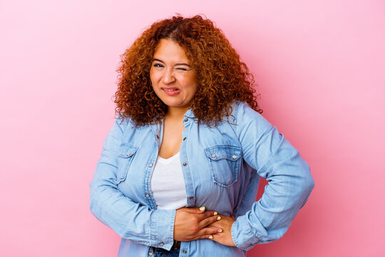 Young Latin Curvy Woman Isolated On Pink Background Having A Liver Pain, Stomach Ache.