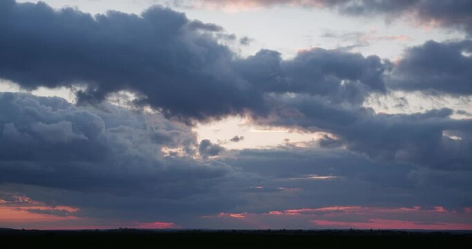 Gloomy clouds at sunset, stormy. Timelapse.