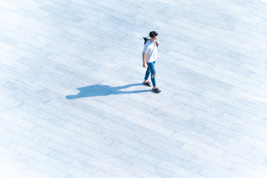 Top Aerial View Man People With Face Mask Walk On Across Pedestrian Concrete With Black Silhouette Shadow On Ground, Concept Of Social New Normal Life Prevention Of Covid Pandemic And Air Pollution.