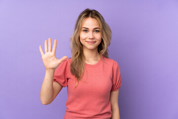Fototapeta premium Teenager Russian girl isolated on purple background counting five with fingers