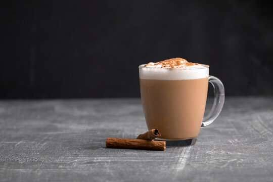 Homemade coffee latte cappuccino in a glass mug on the grey background