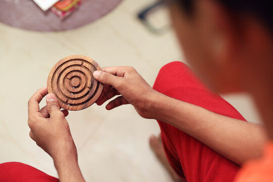 Indian Boy Paying Wooden Labyrinth Maze Toy Game 