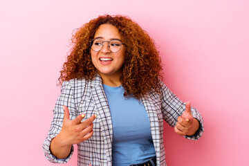 Young latin curvy woman isolated on pink background joyful laughing a lot. Happiness concept.