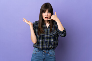 Young Ukrainian woman isolated on purple background making phone gesture and doubting