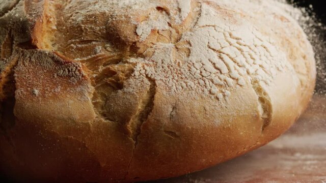 Close up shot of freshly baked bread falling in slow motion