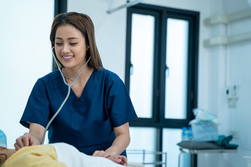 Female doctor examining female patient with his stethoscope at the hospital,Health insurance and medical care contract.