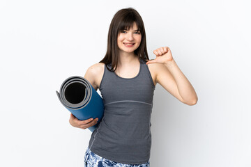 Ukrainian sport girl with mat isolated on blue background proud and self-satisfied