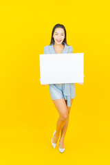 Portrait beautiful young asian woman smile with empty white billboard