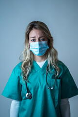 Depressed and tired female Doctor or Nurse Wearing Protective Medical Face Mask portrait