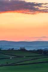 Naklejka na ściany i meble Sunset over Totnes fields, Berry Pomeroy Village, Devon, England, Europe