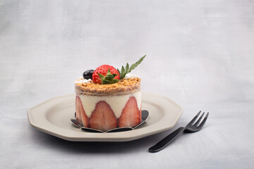 Fresh strawberry cake with cream in close up.