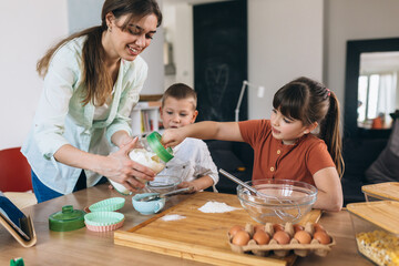 mother with her children baking at home