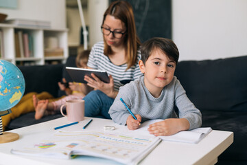 child does homework sitting in living room