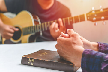 Christian family worship God in home, with a guitar and the Holy Bible. praise and worship concept - obrazy, fototapety, plakaty